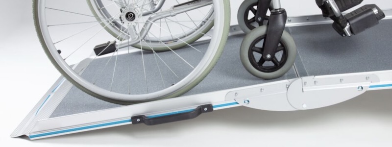 Wheelchair going up portable ramp Wheelchair Accessible 