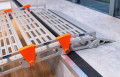 Close up of rest on connection on a step of a portable rollable aluminium wheelchair ramp