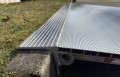 Pallet truck ramp resting on kerb 