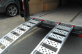Motorcycle ramps resting on vehicle 