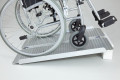 Manual wheelchair going up wheelchair ramp 