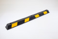 Black and yellow wheel stop, pre-drilled holes