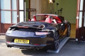 Sports car driving in to a showroom 