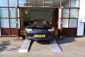 Sports car loading in to show room 