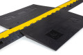 Black and yellow wheelchair ramp cable protector