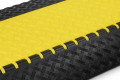Floor cable protector with anti-slip surface