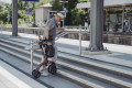 Lightweight rollator folded being lifted up steps