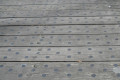Black discs on wood 