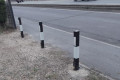 Removable parking bollards installed on driveway with white reflectors