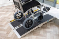 Wheelchair going up multifold wheelchair ramp onto step
