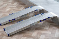 Folding wheelchair ramps resting on step