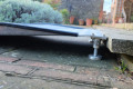 Adjustable legs on threshold ramp 