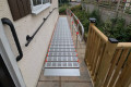Portable wheelchair ramp with single handrail