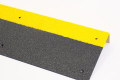 Black and yellow anti-slip stair tread with nosing and pre-drilled fixing points 