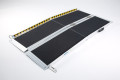 Multi-fold pet ramp on a white background with hazard tape