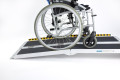 Multifold ramp with a wheelchair going up it