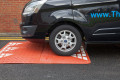 Red speed cushion on a tarmac surface