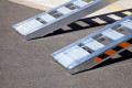 Pair of loading ramps resting on ground 