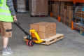 Man moving a pallet using a pallet truck 