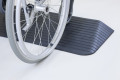 Wheelchair going up threshold ramp