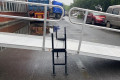 Joining support connecting two wheelchair ramps together 
