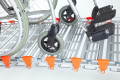 Manual wheelchair on a portable aluminium wheelchair ramp
