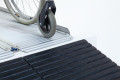 Manual wheelchair overcome threshold with a ramp 