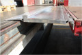 Hinged tailboard accessing loading bay