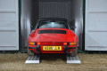 Red car going into container up ramps