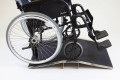 Wheelchair on bridge threshold ramp