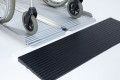 manual wheelchair overcoming threshold with folding ramp and rubber ramp 