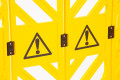 Yellow barrier with warning signs 