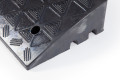 Cable channels on black rubber kerb ramp 
