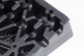 Cable channels underneath black rubber kerb ramps 