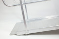 Side view of wheelchair ramp with handrails on a white background