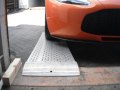 Car loading ramp resting on container 