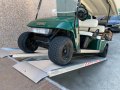 Golf buggy going up alloy ramps 