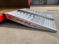 pair of aluminium container ramps resting on a container