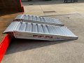 Side view of a pair of aluminium container ramps