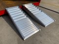 Pair of aluminium container ramps resting on container