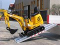 Digger driving up alloy ramps 
