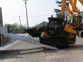 Loader driving on to loading ramps 