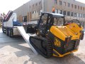 Skid steer loading driving on to loading ramps 