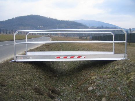 Vehicle gangway resting on either side of trench 