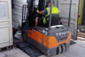 Forklift driving up rubber container ramp 