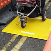Pushchair passing over the trench cover 