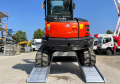 digger driving up vehicle ramps