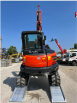 Digger driving up alloy ramps 
