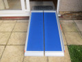 Premium wheelchair ramp resting on threshold