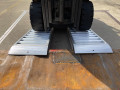 Forklift going into pair of aluminium container ramps 
